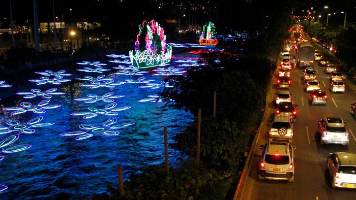 People walk in front of the traditional Christmas lights in Medellin, Colombia, on December 8, 2022. (Photo by Freddy BUILES / AFP) (Photo by FREDDY BUILES/AFP via Getty Images)