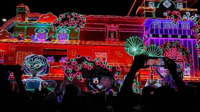 People walk in front of the traditional Christmas lights in Medellin, Colombia, on December 8, 2022. (Photo by Freddy BUILES / AFP) (Photo by FREDDY BUILES/AFP via Getty Images)