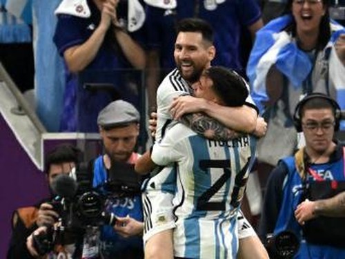 Argentinas defender #26 Nahuel Molina celebrates with Argentinas forward #10 Lionel Messi after scoring his teams first goal during the Qatar 2022 World Cup quarter-final football match between Netherlands and Argentina at Lusail Stadium, north of Doha, on December 9, 2022. (Photo by MANAN VATSYAYANA / AFP)