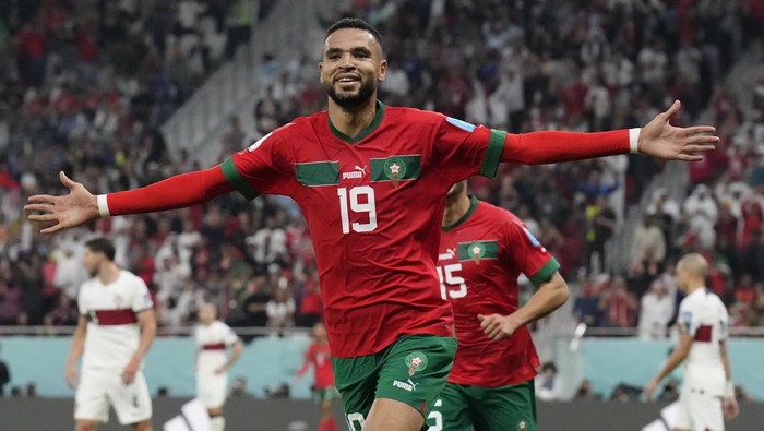Moroccos Youssef En-Nesyri celebrates after scoring his sides first goal during the World Cup quarterfinal soccer match between Morocco and Portugal, at Al Thumama Stadium in Doha, Qatar, Saturday, Dec. 10, 2022. (AP Photo/Martin Meissner)