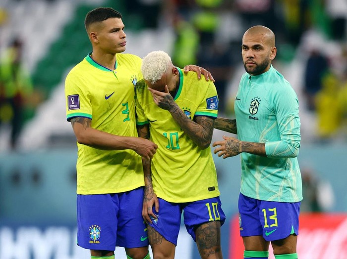 Soccer Football - FIFA World Cup Qatar 2022 - Quarter Final - Croatia v Brazil - Education City Stadium, Doha, Qatar - December 9, 2022 Brazil's Thiago Silva, Neymar and Dani Alves look dejected after being eliminated from the World Cup REUTERS/Matthew Childs