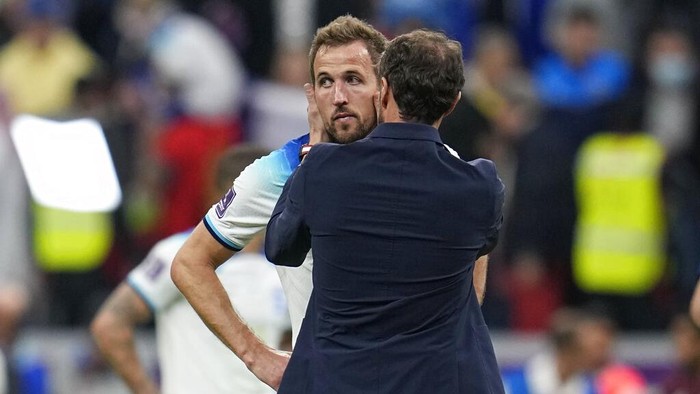 Englands Harry Kane is comforted by head coach Gareth Southgate after losing 1-2 against France during the World Cup quarterfinal soccer match between England and France, at the Al Bayt Stadium in Al Khor, Qatar, Sunday, Dec. 11, 2022. (AP Photo/Abbie Parr)