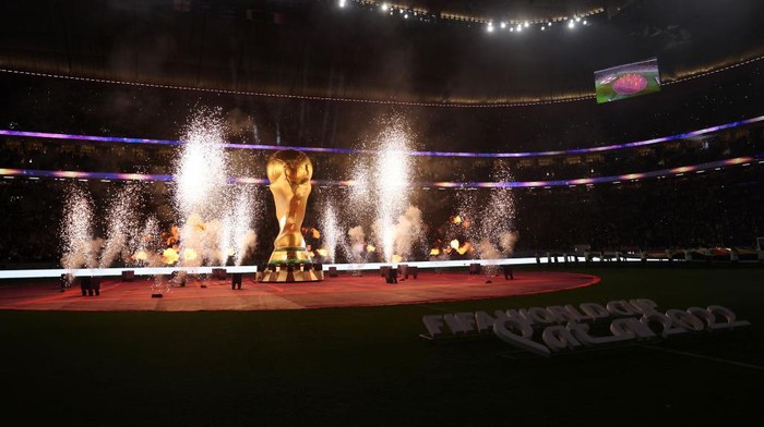 AL KHOR, QATAR - DECEMBER 10: Pyrotechnics explode around a giant World Cup trophy prior to the FIFA World Cup Qatar 2022 quarter final match between England and France at Al Bayt Stadium on December 10, 2022 in Al Khor, Qatar. (Photo by Julian Finney/Getty Images)