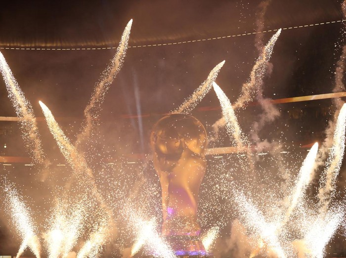 Fireworks go off around a giant replica of the World Cup trophy before the start of the Qatar 2022 World Cup quarter-final football match between England and France at the Al-Bayt Stadium in Al Khor, north of Doha, on December 10, 2022. (Photo by ADRIAN DENNIS / AFP) (Photo by ADRIAN DENNIS/AFP via Getty Images)