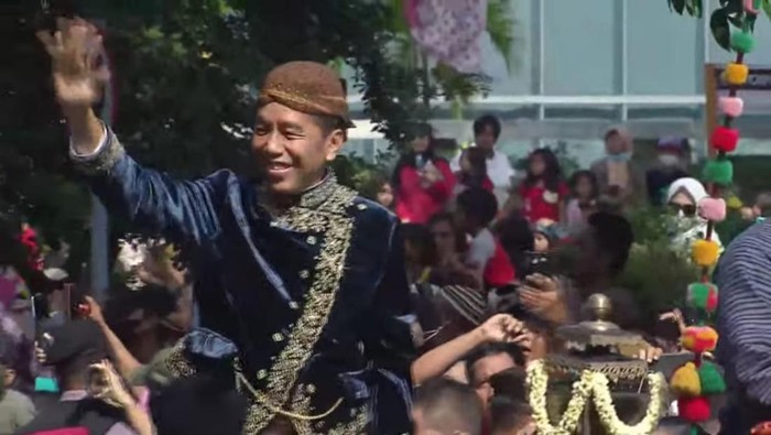 Presiden Jokowi bagi-bagi kaus di acara kirab Kaesang dengan Erina (Tangkapan layar YouTube)