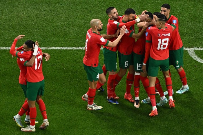 Moroccos forward #19 Youssef En-Nesyri (C) celebrates scoring his teams first goal with teammates during the Qatar 2022 World Cup quarter-final football match between Morocco and Portugal at the Al-Thumama Stadium in Doha on December 10, 2022. (Photo by MANAN VATSYAYANA / AFP)