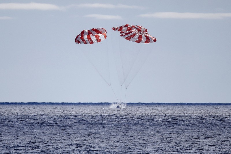 AT SEA, PACIFIC OCEAN - DECEMBER 11: NASA's Orion Capsule splashes down after a successful uncrewed Artemis I Moon Mission on December 11, 2022 seen from aboard the U.S.S. Portland in the Pacific Ocean off the coast of Baja California, Mexico. The 26-day mission took the Orion spacecraft around the moon and back, completing a historic test flight coinciding with the 50th anniversary of the landing of Apollo 17 on the moon, the last time NASA astronauts walked there. (Photo by Caroline Brehman-Pool/Getty Images)