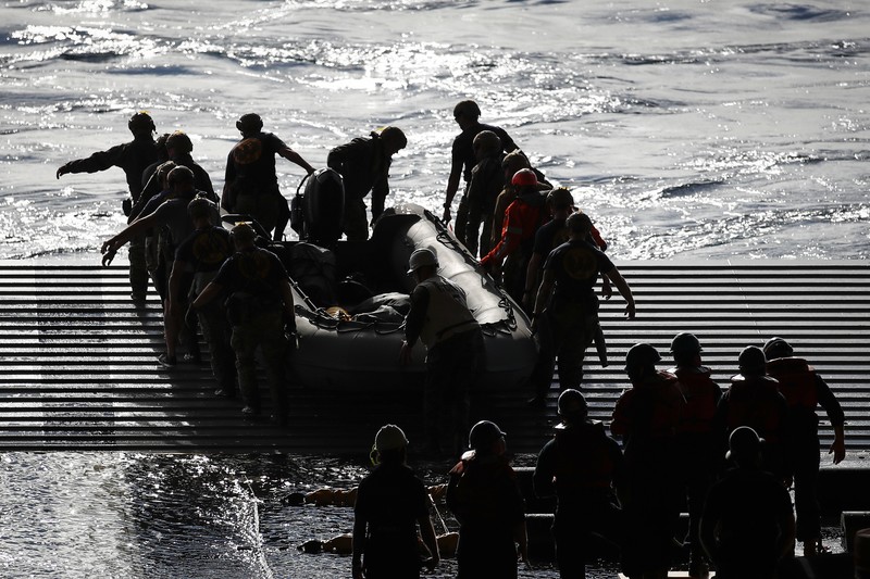 AT SEA, PACIFIC OCEAN - DECEMBER 11: U.S. Navy divers secure NASA's Orion Capsule during recovery operations after it splashed down following a successful uncrewed Artemis I moon mission on December 11, 2022 seen from aboard the U.S.S. Portland in the Pacific Ocean off the coast of Baja California, Mexico. A 26-day mission took the Orion spacecraft to the moon and back which completed a historic test flight that coincided with the 50th anniversary of the landing of Apollo 17 on the moon, the last time that NASA astronauts walked there. (Pool photo by Mario Tama/Getty Images)