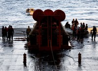 AT SEA, PACIFIC OCEAN - DECEMBER 11: U.S. Navy divers secure NASAs Orion Capsule during recovery operations after it splashed down following a successful uncrewed Artemis I moon mission on December 11, 2022 seen from aboard the U.S.S. Portland in the Pacific Ocean off the coast of Baja California, Mexico. A 26-day mission took the Orion spacecraft to the moon and back which completed a historic test flight that coincided with the 50th anniversary of the landing of Apollo 17 on the moon, the last time that NASA astronauts walked there. (Pool photo by Mario Tama/Getty Images)