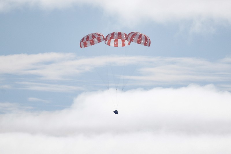 AT SEA, PACIFIC OCEAN - DECEMBER 11: U.S. Navy divers secure NASA's Orion Capsule during recovery operations after it splashed down following a successful uncrewed Artemis I moon mission on December 11, 2022 seen from aboard the U.S.S. Portland in the Pacific Ocean off the coast of Baja California, Mexico. A 26-day mission took the Orion spacecraft to the moon and back which completed a historic test flight that coincided with the 50th anniversary of the landing of Apollo 17 on the moon, the last time that NASA astronauts walked there. (Pool photo by Mario Tama/Getty Images)