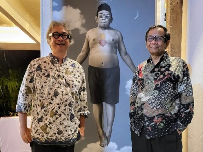 Butet dan Mahfud Md berfoto di depan lukisan Gus Dur Moksa Menuju Surga karya Butet Kartaredjasa dan Sigit Santosa. (Sumber: Akun Twitter Mahfud Md)