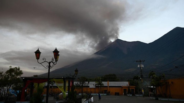 A plume of ash and smoke rises from the Fuego volcano, as seen from Alotenango, a municipality in Sacatepequez department 65 kilometers southwest of Guatemala City on December 11, 2022. - The Fuego volcano, which in 2018 triggered an avalanche that left 215 people dead in Guatemala, has erupted again spewing lava and ash and forcing authorities in Guatemala City to close the country's largest airport and a major highway. (Photo by Johan ORDONEZ / AFP) (Photo by JOHAN ORDONEZ/AFP via Getty Images)