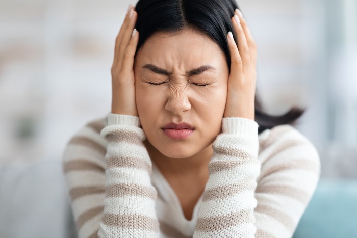 Emotional Asian Woman Covering Ears With Hands At Home, Annoyed Millennial Korean Lady Suffering Stress Or Headache, Can Not Bear Sound, Feeling Desperate And Having Nervous Breakdown, Closeup Shot