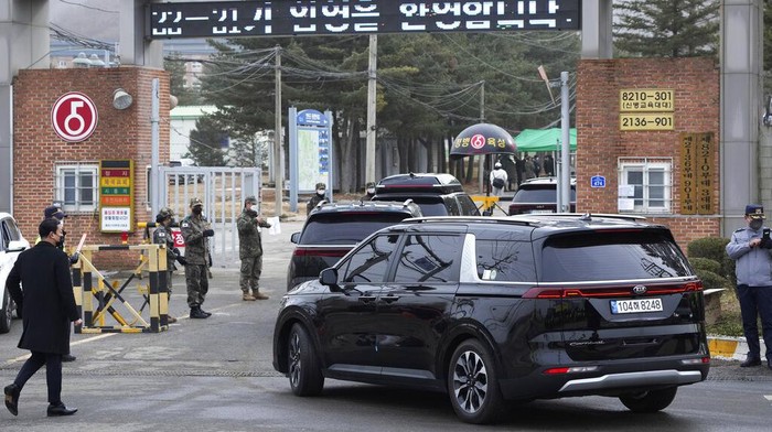 A convoy of vehicles, one of them carrying K-pop band BTS's member Jin arrive at an army training center in Yeoncheon, South Korea, Tuesday, Dec. 13, 2022. Jin was set to enter a frontline South Korean boot camp Tuesday to start his 18 months of mandatory military service, as fans gathered near the base to say goodbye to their star. (AP Photo/Ahn Young-joon)