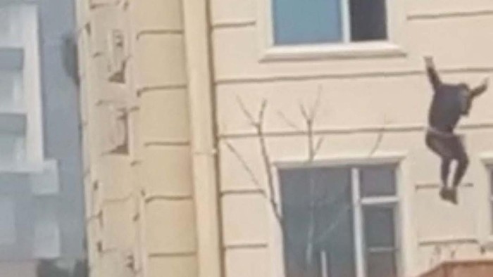 A person jumps from a hotel window in Shahr-e-Naw neighborhood amid sounds of gunfire in Kabul, Afghanistan December 12, 2022 in this still image from video. Aamaj News via REUTERS  THIS IMAGE HAS BEEN SUPPLIED BY A THIRD PARTY. NO RESALES. NO ARCHIVES. MANDATORY CREDIT