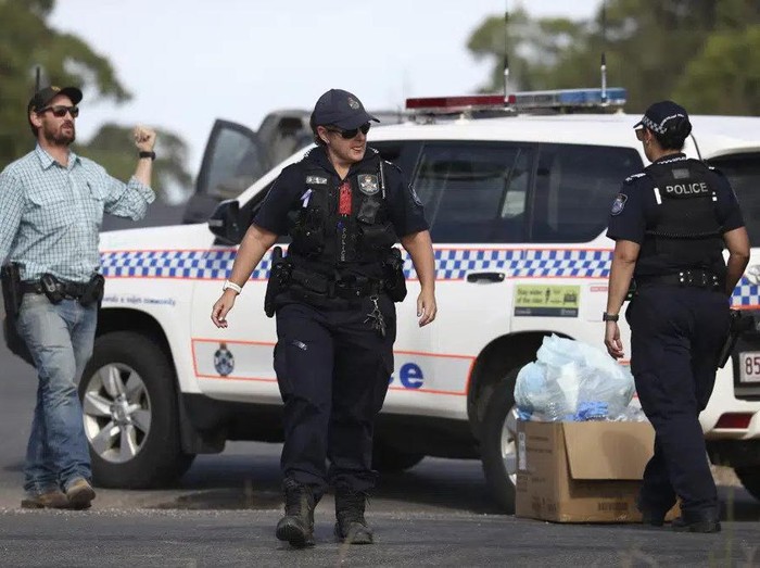 Police work near the scene of a fatal shooting in Wieambilla, Australia, Tuesday, Dec. 13, 2022. Multiple people, including a few police officers, were shot and killed at a property in rural Australia after officers who arrived to investigate reports of a missing person were ambushed, authorities said. (Jason OBrien/AAP Image via AP)