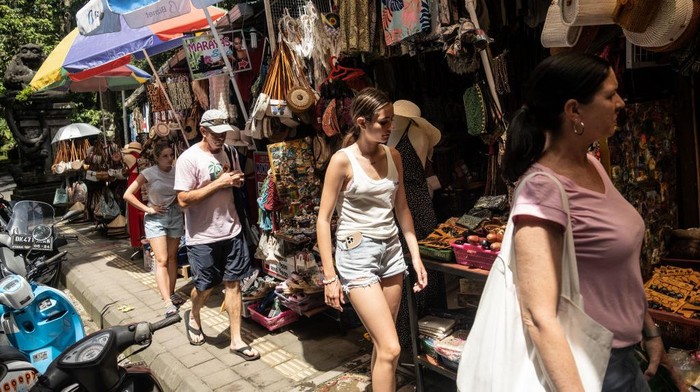 UBUD, BALI, INDONESIA - DECEMBER 8: Foreign tourists walk at the Ubud street art market on December 8, 2022 in Ubud, Bali, Indonesia. Indonesias parliament voted to pass a law that bans extramarital sex on Tuesday, in a move that critics quoted in local media have said will severely impact the tourism industry. Regions like Bali rely heavily on an influx of foreign tourists to keep their economies afloat, and the new law has raised concerns just as international arrivals start to pick up again post-pandemic.  (Photo by Agung Parameswara/Getty Images)