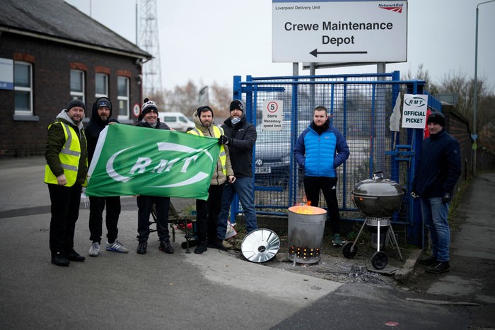 CREWE, UNITED KINGDOM- DECEMBER 13: RMT Union members picket outside Crewe rail maintenance centre as they strike over pay and working terms on December 13, 2022 in Crewe, United Kingdom. Members of the National Union of Rail, Maritime and Transport Workers (RMT) are striking across the UK in the run-up to Christmas and over the festive period holding out for a pay increase above the rate of inflation which is currently at 11%. (Photo by Christopher Furlong/Getty Images)