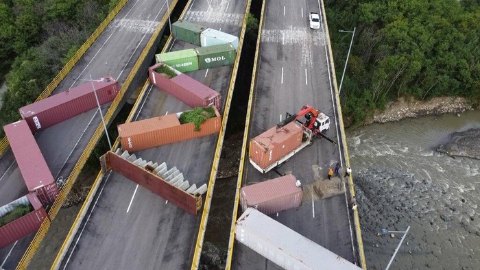 3 Tahun Diblokir, Jembatan Perbatasan Venezuela-Kolombia Siap Dibuka Lagi Venezuelan personnel remove containers that were blocking the Tienditas International Bridge, the international border between Venezuela and Colombia, in Cucuta, Colombia, Tuesday, Dec.12, 2022. Venezuelan President Nicolás Maduro announced his decision to fully open the border crossings with Colombia starting in January. (AP Photo/Maria Baron)