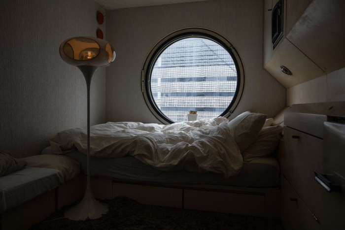 TOKYO, JAPAN - DECEMBER 07: [EDITORIAL USE ONLY] A furnished capsule room is pictured in Nakagin Capsule Tower on December 7, 2021 in Tokyo, Japan. The iconic building is a mixed-use residential and office tower designed by architect Kisho Kurokawa and is considered a a rare example of Japan's post-war Metabolism architectural movement. Despite an ongoing protest to save the building, it is expected to be demolished next year. (Photo by Carl Court/Getty Images)