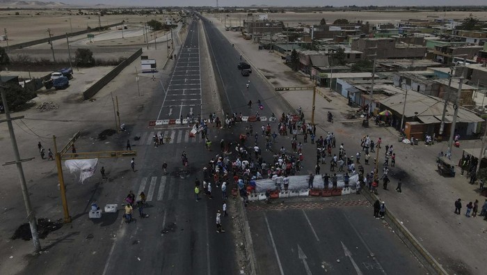 Truckers are backed up on the Pan-American highway because supporters of ousted Peruvian President Pedro Castillo are blocking it in protest of his detention, in Ica, Peru, Tuesday, Dec. 13, 2022. Castillo said Tuesday he is being 
