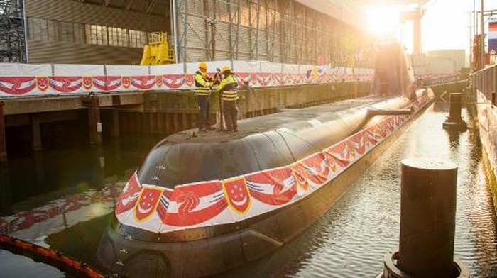 Workers of thyssenkrupp marine systems shipyard fix a bottle of champagne as they prepare the christening of a new Type 218SG submarine 
