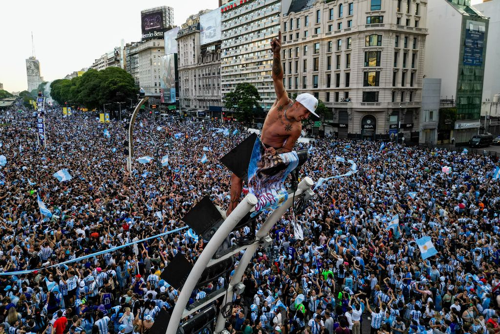 BUENOS AIRES, ARGENTINA - DECEMBER 13: Fans of Argentina celebrate at the Obelisk after their team's victory in the semi-final match of FIFA World Cup Qatar 2022 between Argentina and Croatia on December 13, 2022 in Buenos Aires, Argentina. (Photo by Tomas Cuesta/Getty Images)