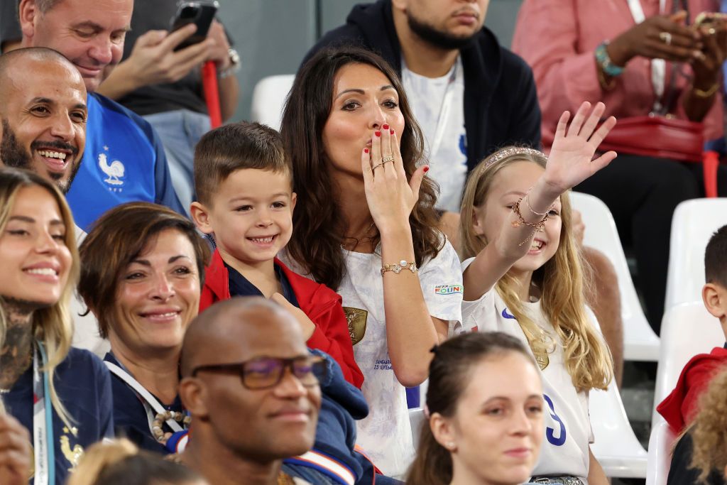 France's forward #09 Olivier Giroud sits with his wife Jennifer after the Qatar 2022 World Cup Group D football match between Tunisia and France at the Education City Stadium in Al-Rayyan, west of Doha on November 30, 2022. (Photo by FRANCK FIFE / AFP) (Photo by FRANCK FIFE/AFP via Getty Images)