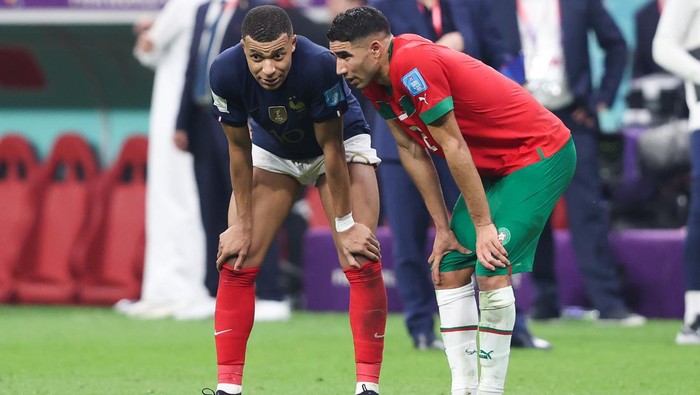 AL KHOR, QATAR - DECEMBER 14: Kylian Mbappe of France speaks with Paris Saint-Germain teammate Achraf Hakimi of Morocco after the FIFA World Cup Qatar 2022 semi final match between France and Morocco at Al Bayt Stadium on December 14, 2022 in Al Khor, Qatar. (Photo by Alex Livesey - Danehouse/Getty Images)