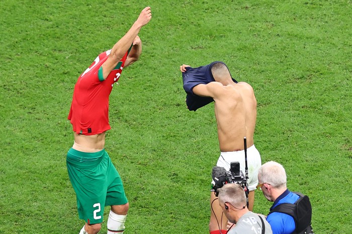 AL KHOR, QATAR - DECEMBER 14: Club team mates Achraf Hakimi of Morocco and Kylian Mbappe of France swap shirts at full time during the FIFA World Cup Qatar 2022 semi final match between France and Morocco at Al Bayt Stadium on December 14, 2022 in Al Khor, Qatar. (Photo by Robbie Jay Barratt - AMA/Getty Images)