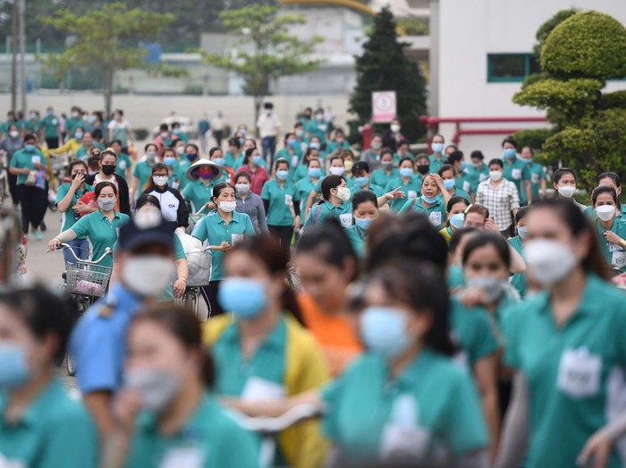 This picture taken on November 30, 2022 shows workers leaving their workplace at Taiwanese Ty Hung factory in Ho Chi Minh City. - Almost half a million workers have been forced to work fewer hours as orders fall in the Southeast Asian country, one of the worlds largest exporters of clothing, footwear and furniture. The cost-of-living crisis in Europe and the United States -- major markets for Vietnamese-produced goods -- has seen the buying power of Western shoppers take a dive. - To go with AFP Focus Vietnam-Economy-Labour by Tran Thi Minh Ha (Photo by Nhac NGUYEN / AFP) / To go with AFP Focus Vietnam-Economy-Labour by Tran Thi Minh Ha (Photo by NHAC NGUYEN/AFP via Getty Images)