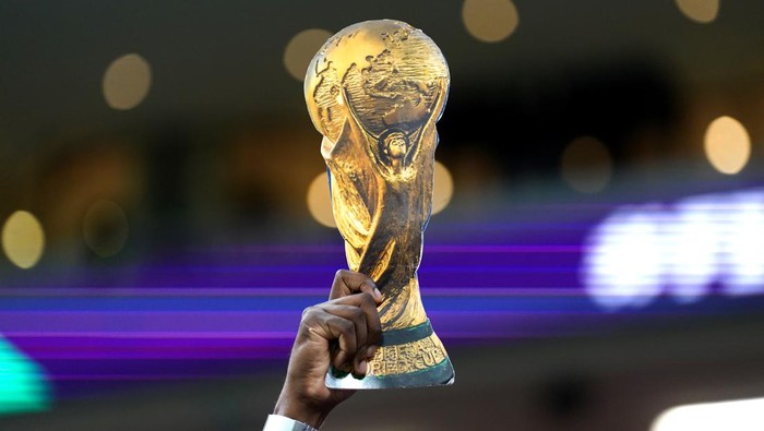 A fan holds up a replica World Cup trophy before the FIFA World Cup Semi-Final match at the Al Bayt Stadium in Al Khor, Qatar. Picture date: Wednesday December 14, 2022. (Photo by Adam Davy/PA Images via Getty Images)