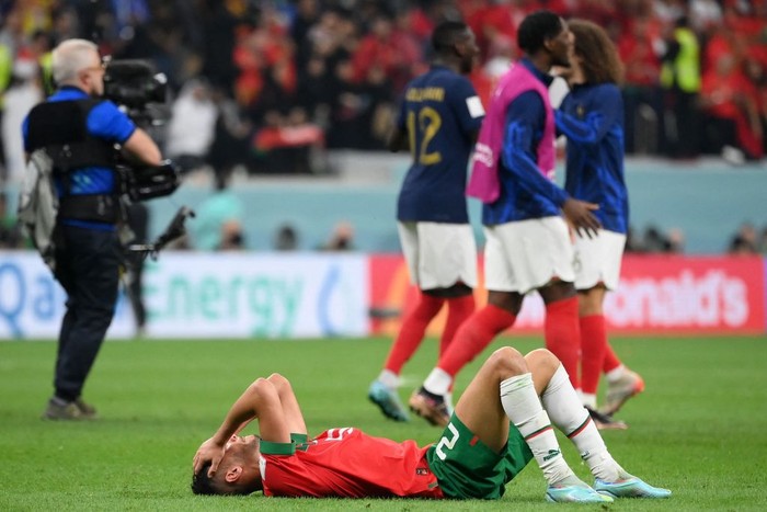 Moroccos defender #20 Achraf Dari reacts at the end of the Qatar 2022 World Cup semi-final football match between France and Morocco at the Al-Bayt Stadium in Al Khor, north of Doha on December 14, 2022. (Photo by FRANCK FIFE / AFP) (Photo by FRANCK FIFE/AFP via Getty Images)