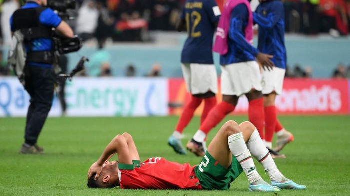 Moroccos defender #20 Achraf Dari reacts at the end of the Qatar 2022 World Cup semi-final football match between France and Morocco at the Al-Bayt Stadium in Al Khor, north of Doha on December 14, 2022. (Photo by FRANCK FIFE / AFP) (Photo by FRANCK FIFE/AFP via Getty Images)