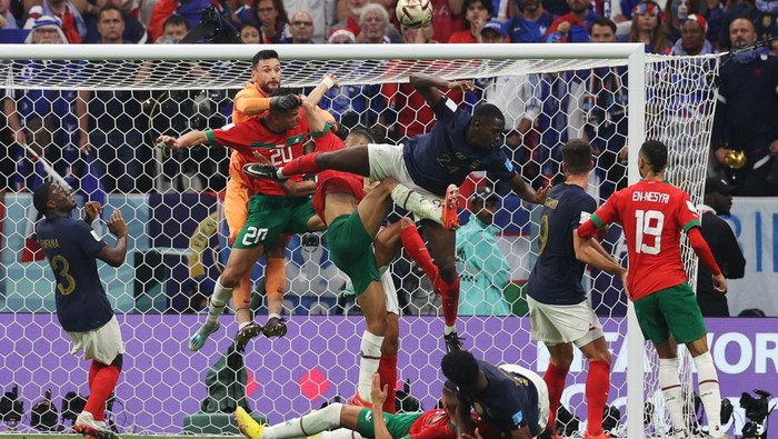 TOPSHOT - Frances goalkeeper #01 Hugo Lloris and players jump for the ball during the Qatar 2022 World Cup semi-final football match between France and Morocco at the Al-Bayt Stadium in Al Khor, north of Doha on December 14, 2022. (Photo by ADRIAN DENNIS / AFP) (Photo by ADRIAN DENNIS/AFP via Getty Images)