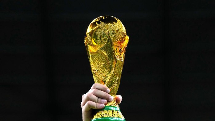 A fan in the stands holds aloft a replica World Cup trophy during the FIFA World Cup Quarter-Final match at the Education City Stadium in Al Rayyan, Qatar. Picture date: Friday December 9, 2022. (Photo by Nick Potts/PA Images via Getty Images)