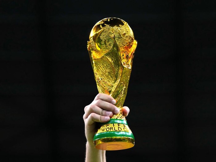 A fan in the stands holds aloft a replica World Cup trophy during the FIFA World Cup Quarter-Final match at the Education City Stadium in Al Rayyan, Qatar. Picture date: Friday December 9, 2022. (Photo by Nick Potts/PA Images via Getty Images)
