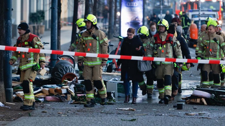 Emergency services work on a street outside a hotel after a leak of the AquaDom aquarium in central Berlin near Alexanderplatz, with water poured out onto the street, in Berlin, Germany, December 16, 2022. REUTERS/Michele Tantussi