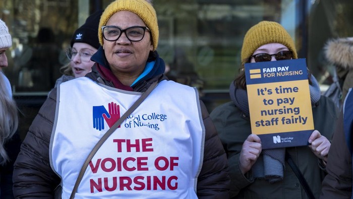 Nurses from the Royal College of Nursing strike for fair pay and working conditions in unprecedented industrial action by nurses outside the Queen Elizabeth Hospital on 15th December 2022 in Birmingham, United Kingdom. This is the first of two planned strikes before the end of the year, with the dispute possibly heading for more in the New Year if the government fails to improve their offer. (photo by Mike Kemp/In Pictures via Getty Images)