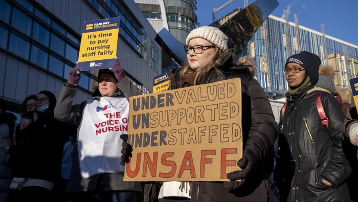 Nurses from the Royal College of Nursing strike for fair pay and working conditions in unprecedented industrial action by nurses outside the Queen Elizabeth Hospital on 15th December 2022 in Birmingham, United Kingdom. This is the first of two planned strikes before the end of the year, with the dispute possibly heading for more in the New Year if the government fails to improve their offer. (photo by Mike Kemp/In Pictures via Getty Images)