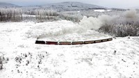Kereta uap melewati lanskap tertutup salju di pegunungan Harz dekat Wernigerode, Jerman, Jumat (9/12/2022). Foto: AP/Matthias Schrader