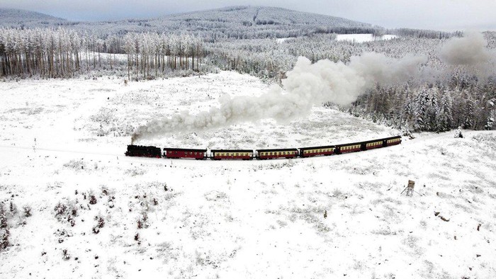 A steam train drives through a snow-covered landscape at the Harz mountains near Wernigerode, Germany, Friday, Dec. 9, 2022. (AP Photo/Matthias Schrader)