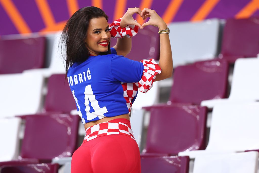 17 December 2022, Qatar, Al-Rajjan: Soccer, World Cup 2022 in Qatar, Croatia - Morocco, third place match, at Chalifa International Stadium, Ivana Knöll, model from Croatia, gestures in the stands before the match. Photo: Tom Weller/dpa (Photo by Tom Weller/picture alliance via Getty Images)