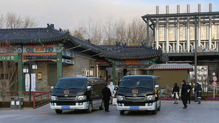 Workers in protective suits move a casket outside a crematorium at a funeral home, amid the coronavirus disease (COVID-19) outbreak in Beijing, China December 17, 2022. REUTERS/Alessandro Diviggiano