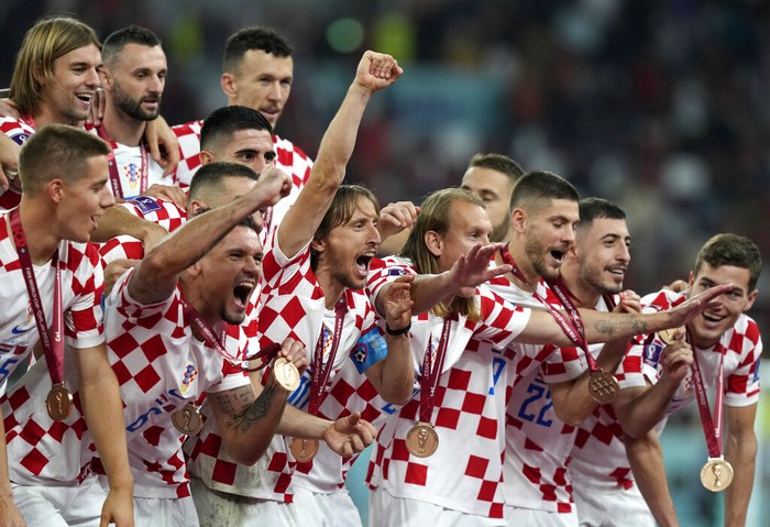 Croatia players celebrate at the end of the World Cup third-place playoff soccer match between Croatia and Morocco at Khalifa International Stadium in Doha, Qatar, Saturday, Dec. 17, 2022. (AP Photo/Frank Augstein)