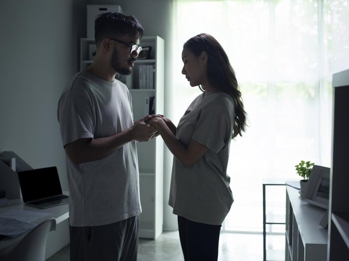1407437174 Young Asian couple holding hands and making up after a fight. Husband and wife try to solve relationship problem and getting back together after an argument.