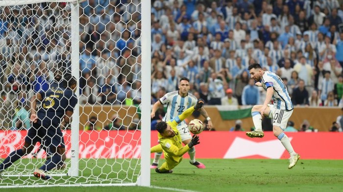 LUSAIL CITY, QATAR - DECEMBER 18: Lionel Messi of Argentina scores the teams third goal past Hugo Lloris of France during the FIFA World Cup Qatar 2022 Final match between Argentina and France at Lusail Stadium on December 18, 2022 in Lusail City, Qatar. (Photo by David Ramos - FIFA/FIFA via Getty Images)