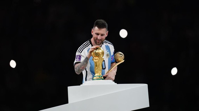 LUSAIL CITY, QATAR - DECEMBER 18: Lionel Messi of Argentina celebrates with World Cup and Golden ball trophies after winning the FIFA World Cup Qatar 2022 Final match between Argentina and France at Lusail Stadium on December 18, 2022 in Lusail City, Qatar. (Photo by Khalil Bashar/Jam Media/Getty Images)
