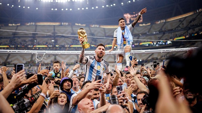 LUSAIL CITY, QATAR - DECEMBER 18: Lionel Messi of Argentina lifts the Fifa World Cup Trophy with Lautaro Martinez after winning the FIFA World Cup Qatar 2022 Final match between Argentina and France at Lusail Stadium on December 18, 2022 in Lusail City, Qatar. (Photo by MB Media/Getty Images)