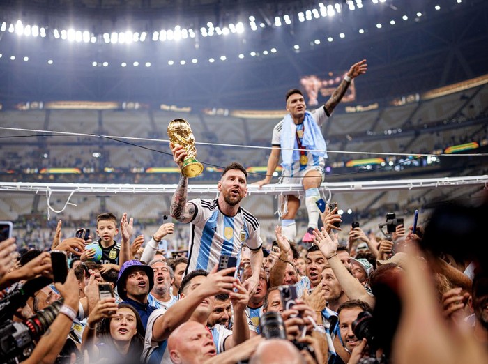 LUSAIL CITY, QATAR - DECEMBER 18: Lionel Messi of Argentina lifts the Fifa World Cup Trophy with Lautaro Martinez after winning the FIFA World Cup Qatar 2022 Final match between Argentina and France at Lusail Stadium on December 18, 2022 in Lusail City, Qatar. (Photo by MB Media/Getty Images)
